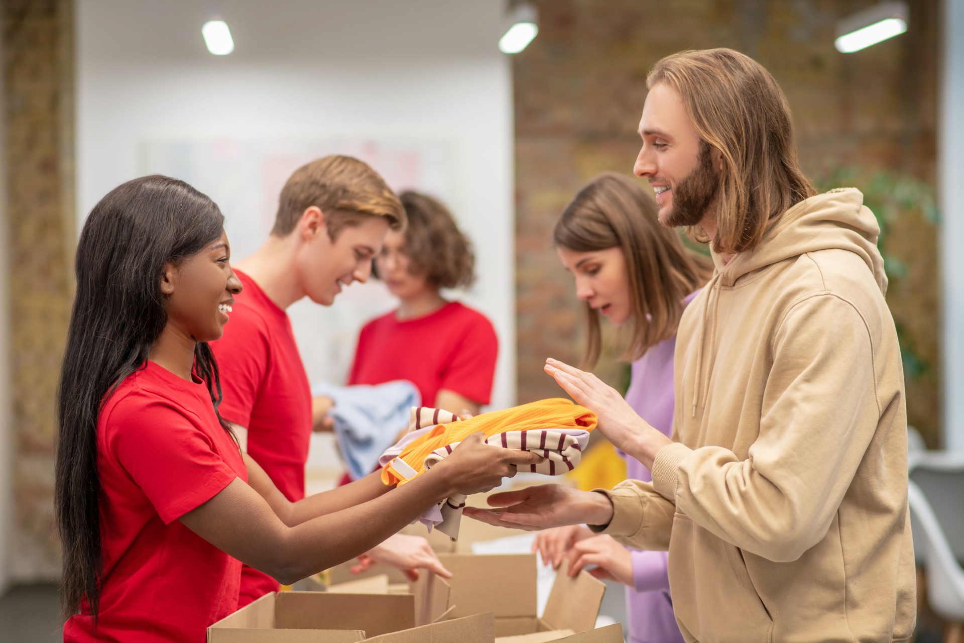 Young people receiving humanitarian aid in volunteer organization